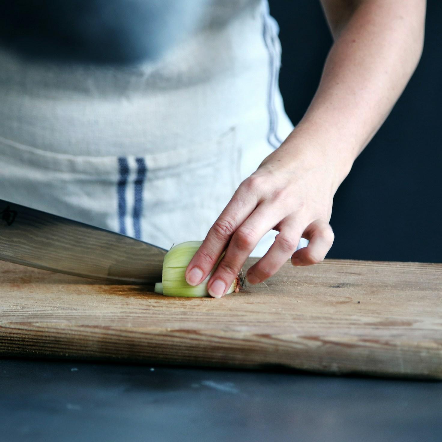 Community members collaborating in a contemporary kitchen, exchanging recipes and techniques